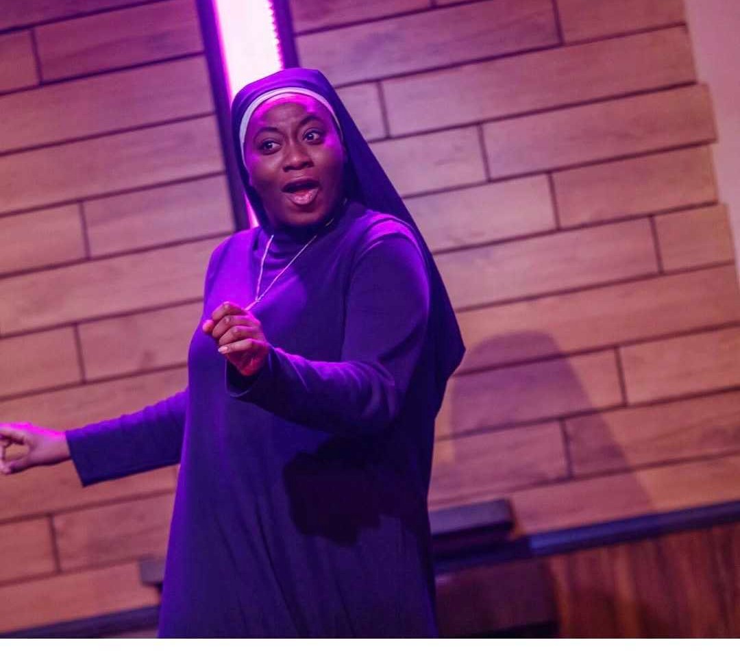 Samantha Turner as Sister Chantelle under purple light