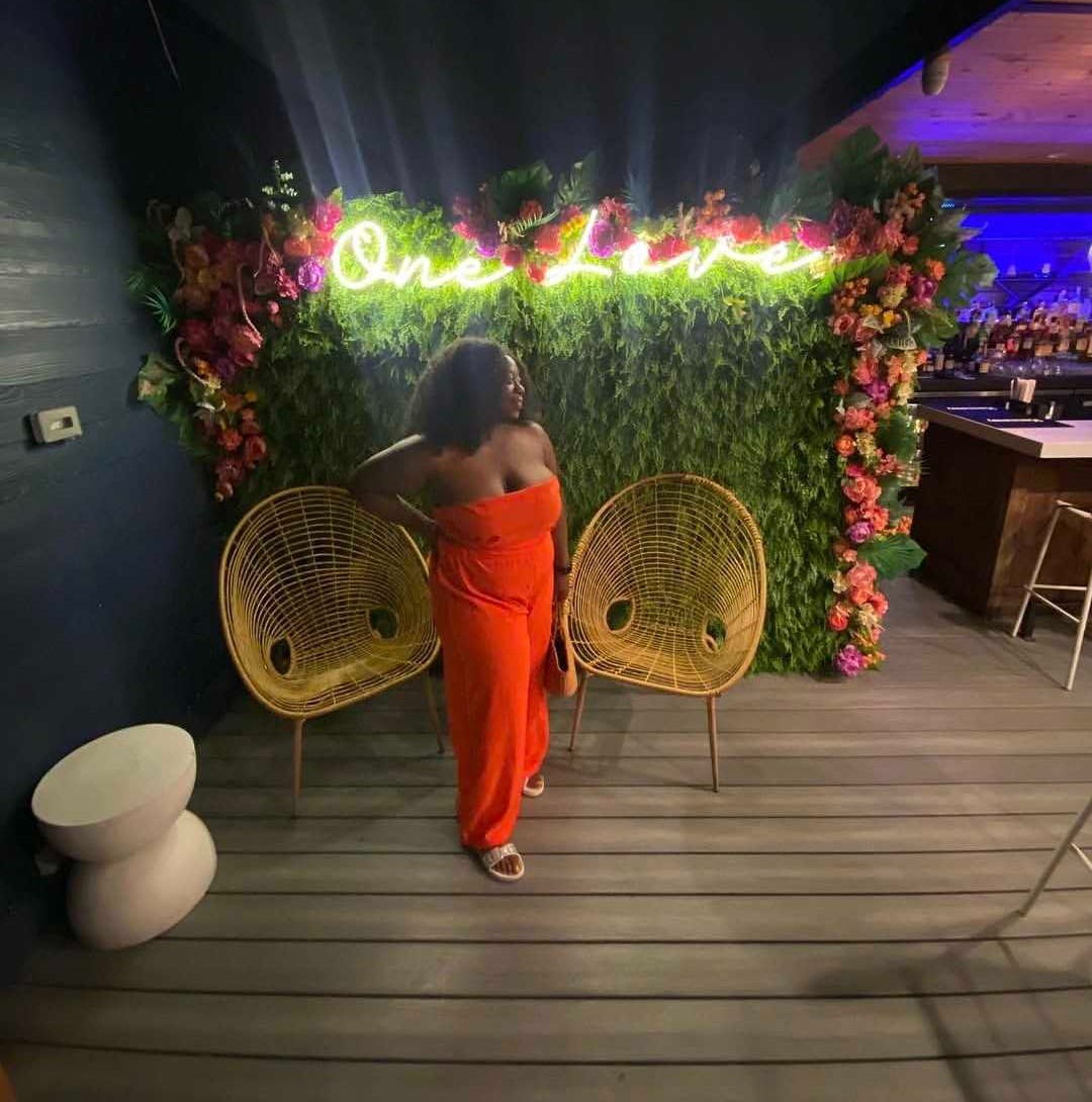 Samantha Turner at the One Love flower wall